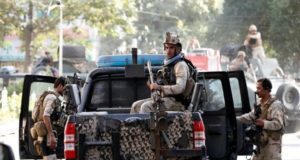 Afghan security forces leave the site of a suicide attack followed by a clash between Afghan forces and insurgents after the attack on Iraq embassy in Kabul, Afghanistan